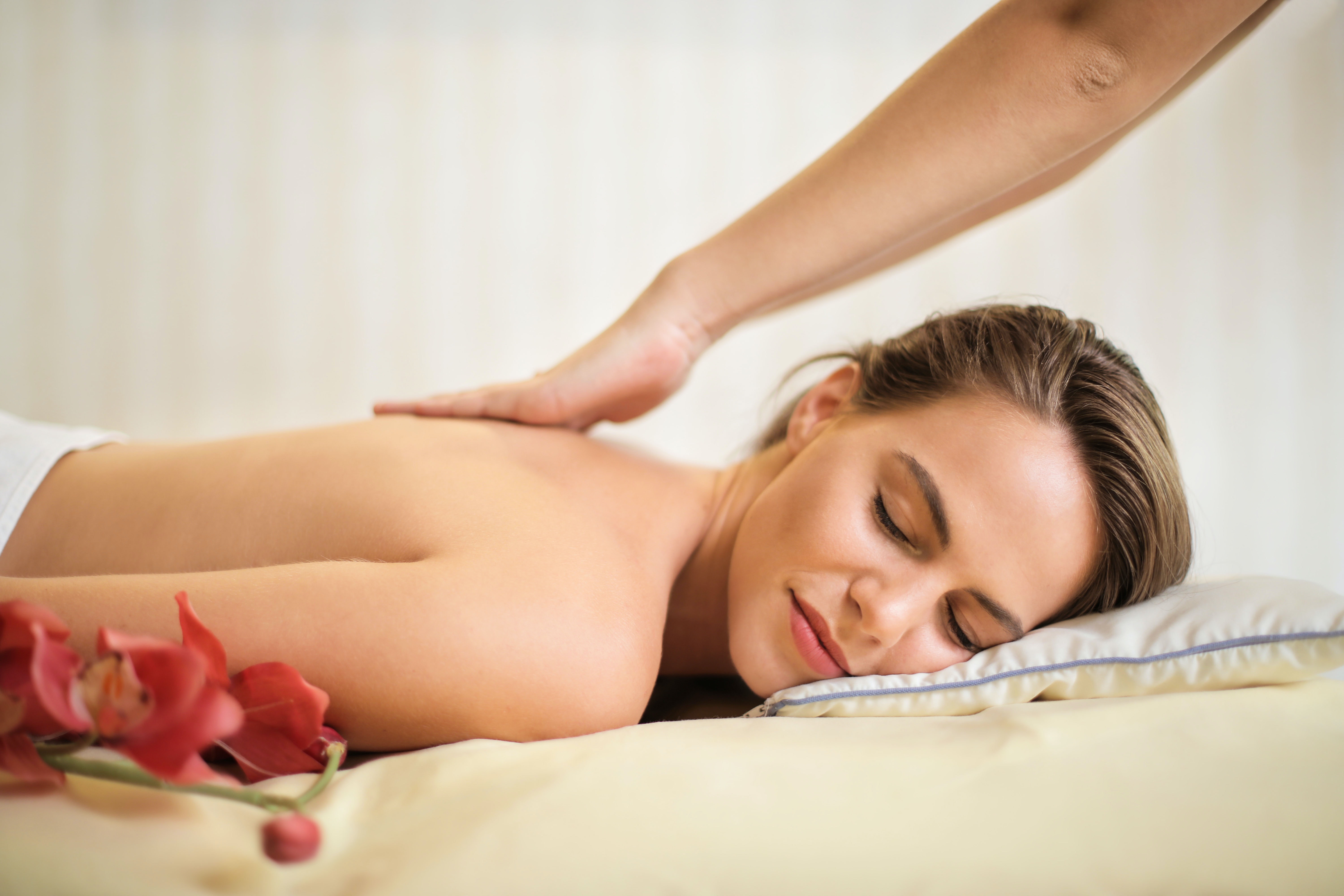 A smiling woman lying on a massage table.